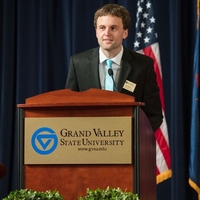 GSA member speaking at a GVSU podium